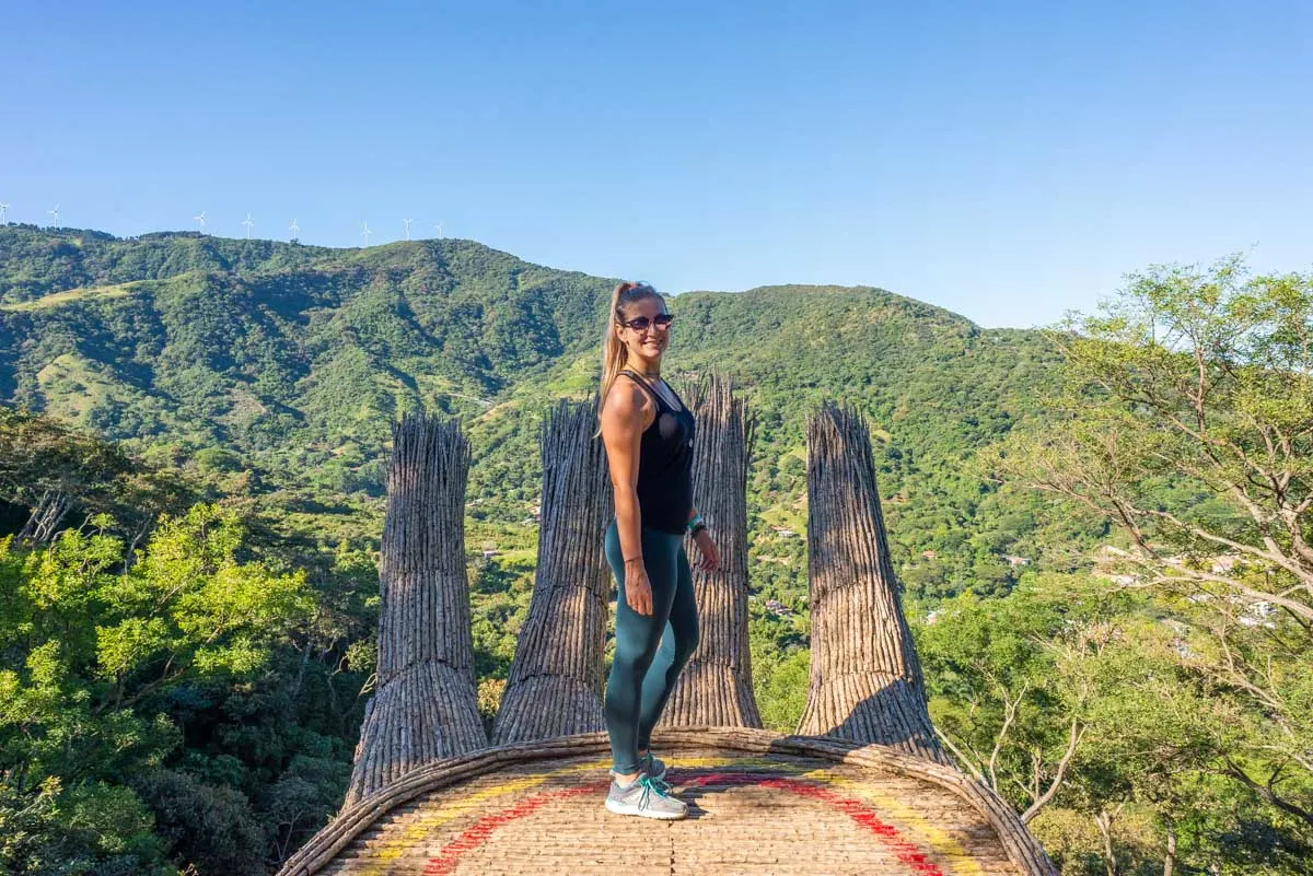 A lady stands on the hand at Mantra Trail hike within Hacienda y Beneficio La Chimba to the Mantra hand