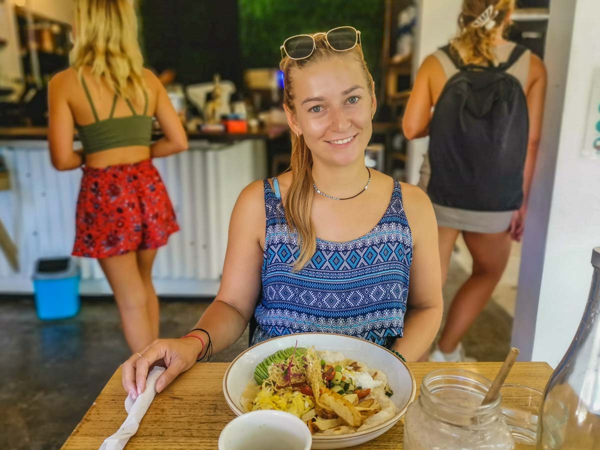 A lady poses with her meal at Destiny Cafe