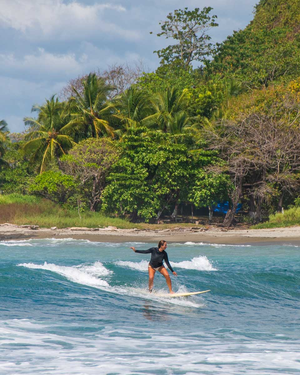A person learns to surf in Santa Teresa
