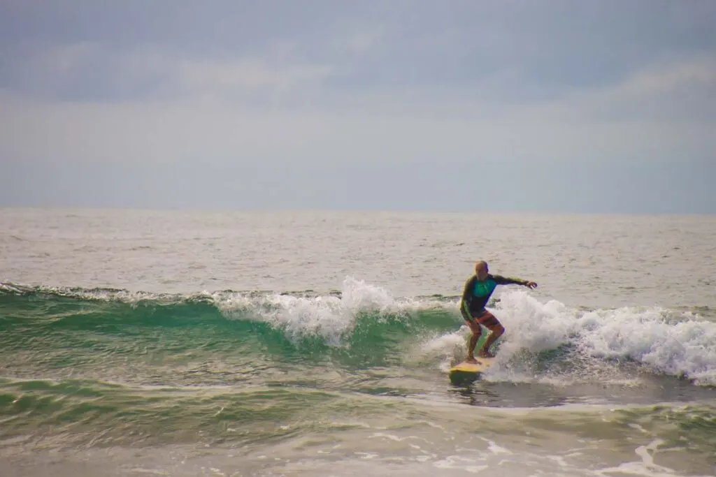 A person surfs at Playa Grande