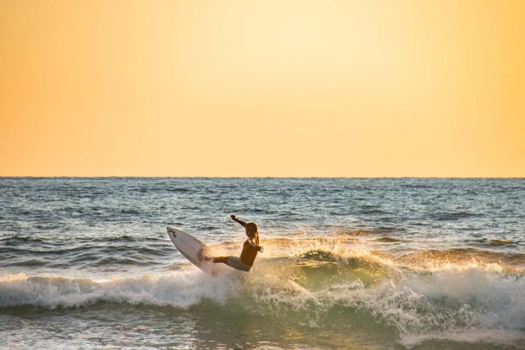 A surfer gets air off a wave in Nosara, Costa Rica