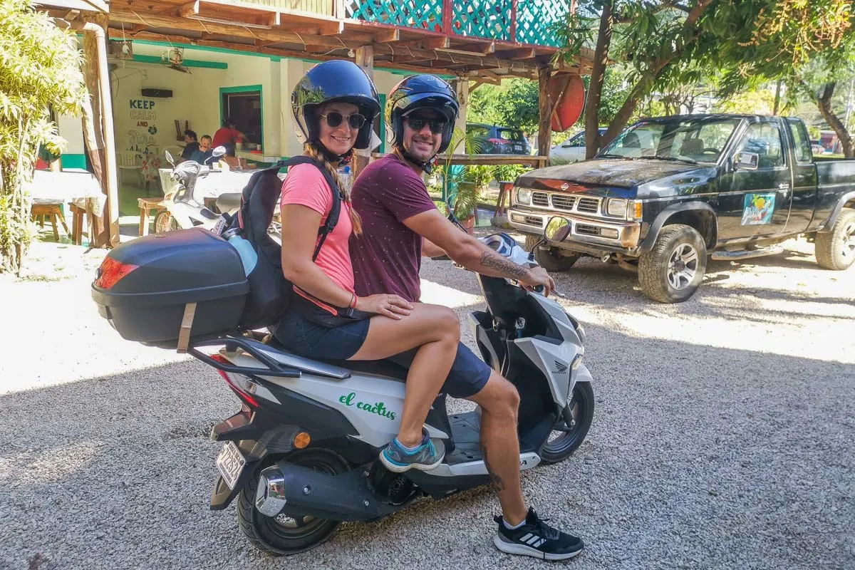 Bailey and Daniel sit on their rental scooter in Samara, Costa Rica