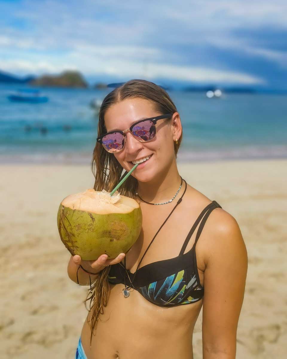 Bailey sips a coconut on Tortuga Island