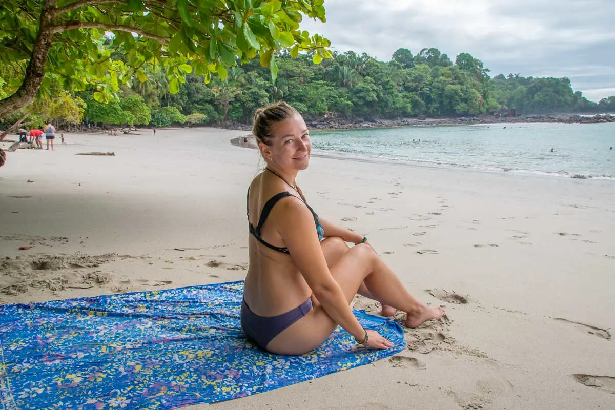 Bailey sits on a beach in Manuel Antonio National Park