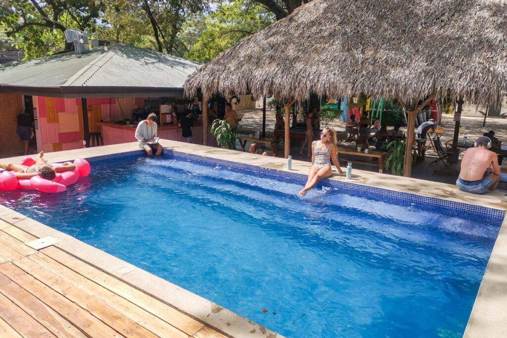 lady sits poolside at Selina Tamarindo, Costa Rica