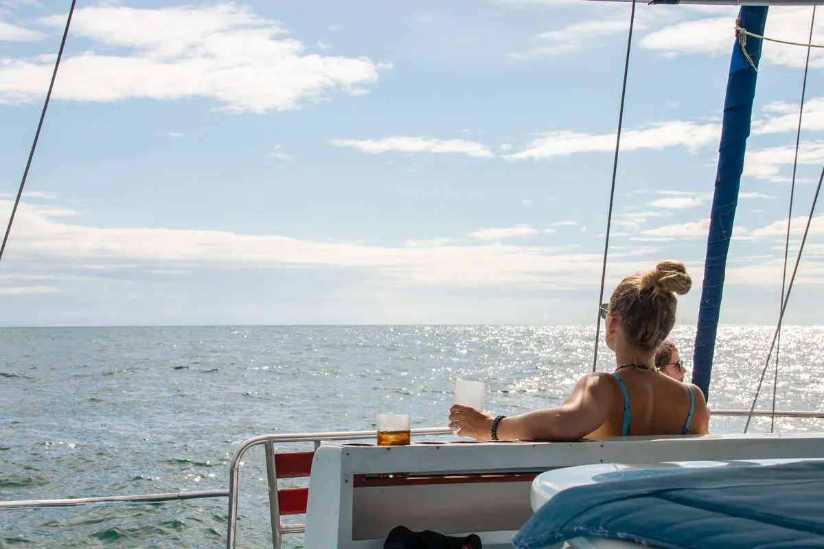 A lady relaxes with a drink in hand on a cruise in Tamarindo, Costa rica