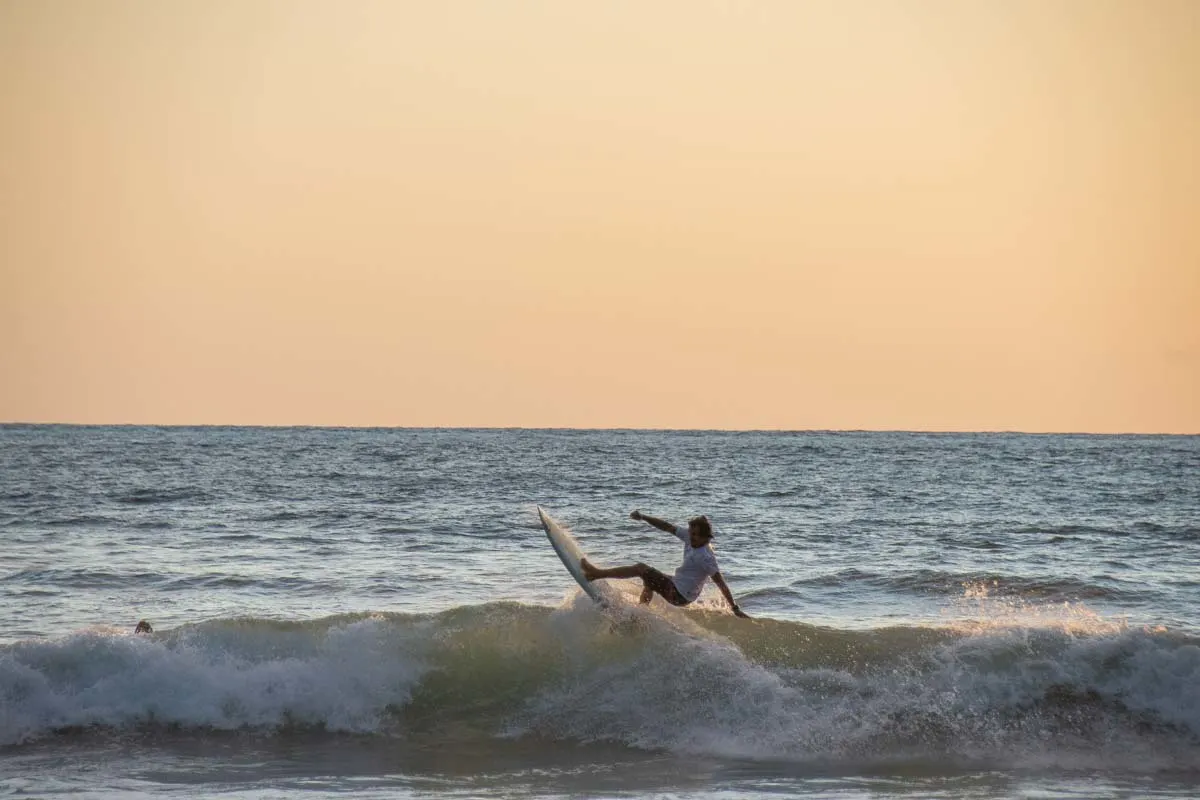 A surfer gets air on a wave in Nosara, Costa Rica