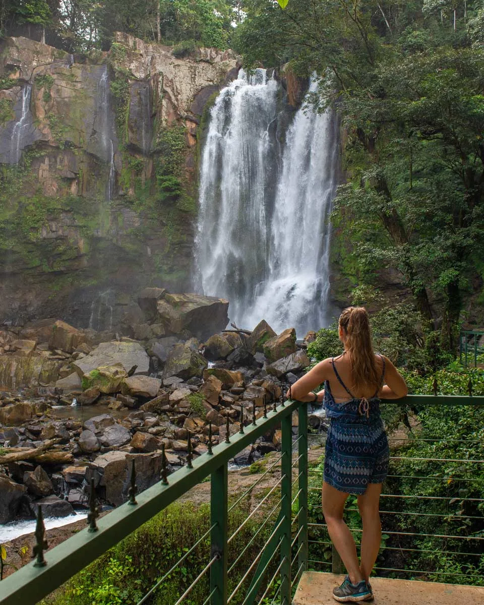 A lady at the viewpoint of the upper Nauyaca Waterfalls 