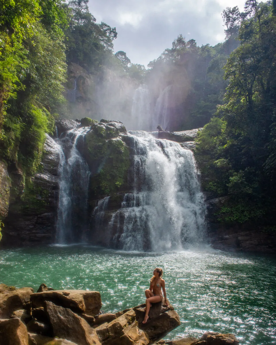 A lady poses for a photo at Nauyaca Waterfalls 