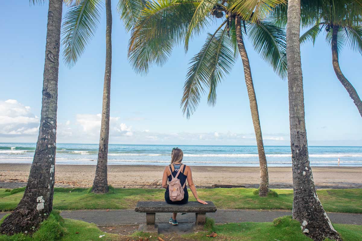 Lady sits on a bench in North Jaco beach