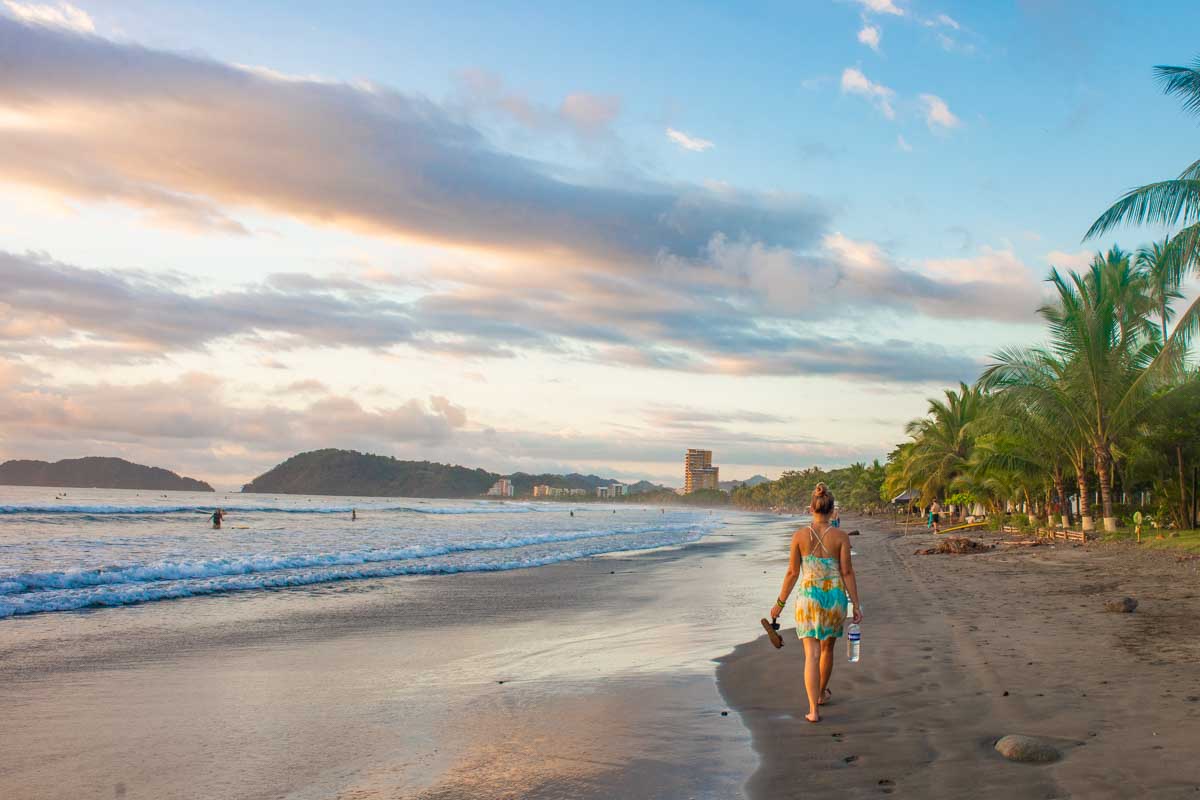 Lady walks along Jaco Beach at sunset, Costa Rica