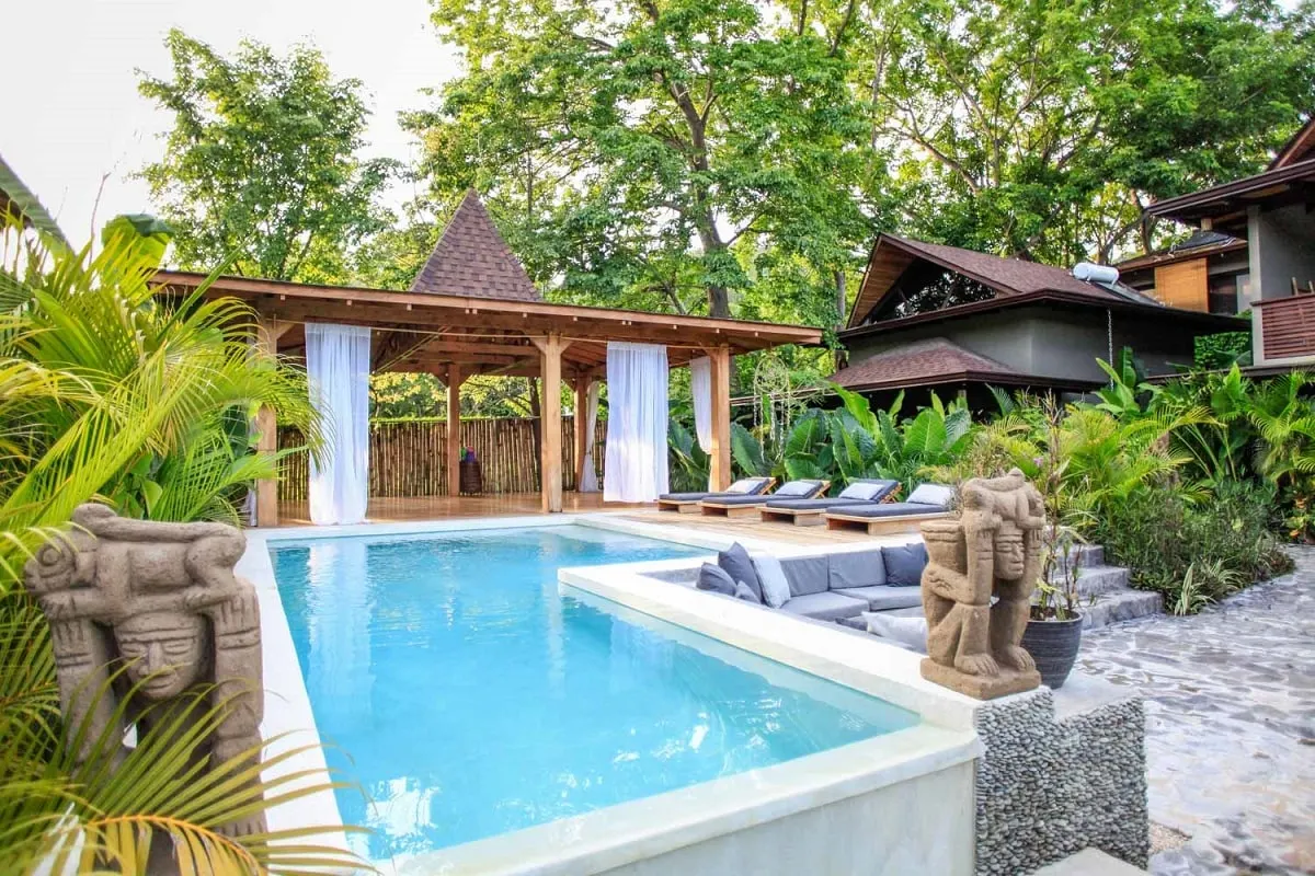 a bright blue pool in the jungle at Lua Villas