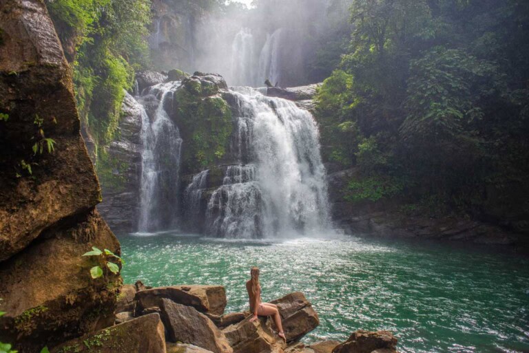 A lady poses for a photo at Nauyaca Waterfalls, Costa rica