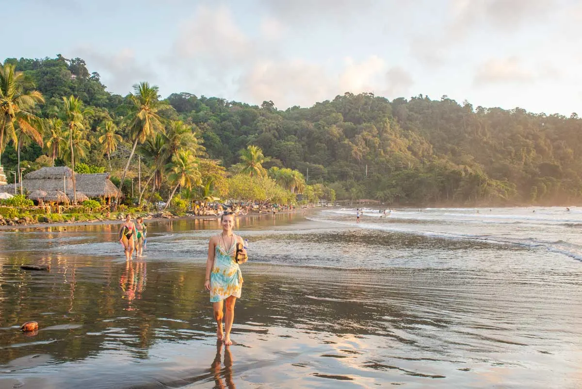 A lady walks along south jaco Beach