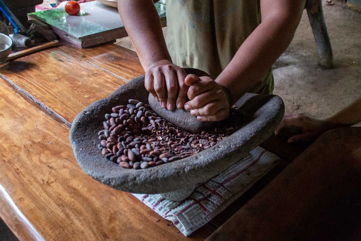 Grinding cacao on a Tio Leo Coffee Tour