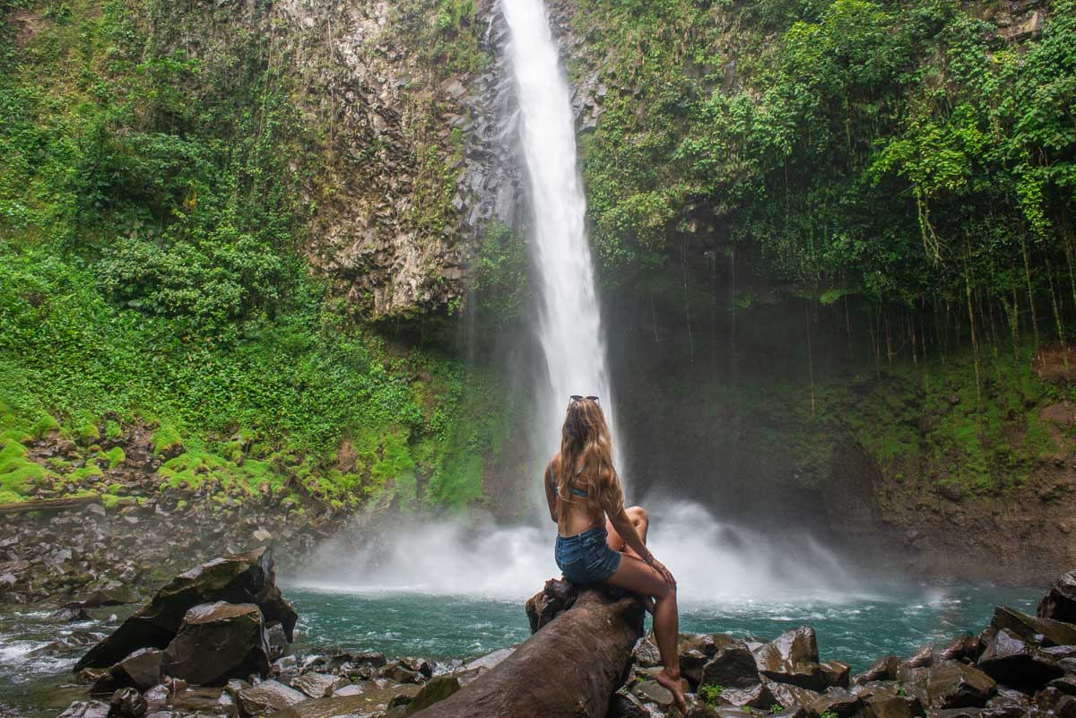 A lady enjoys the view of LA Fortuna Waterfall