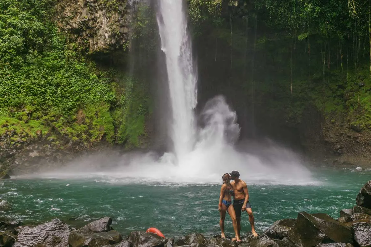 Bailey and Daniel kiss at La Fortuna Waterfall