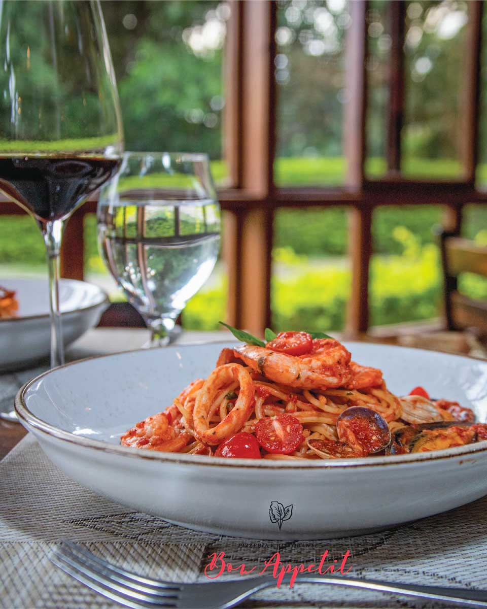 A pasta dish and glass of wine at Bon Appetit, Monteverde, Costa rica