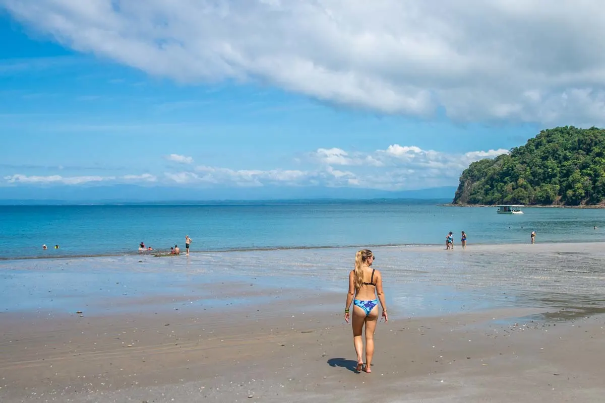 Lady walks to the ocean at Playa Mantas, Costa Rica
