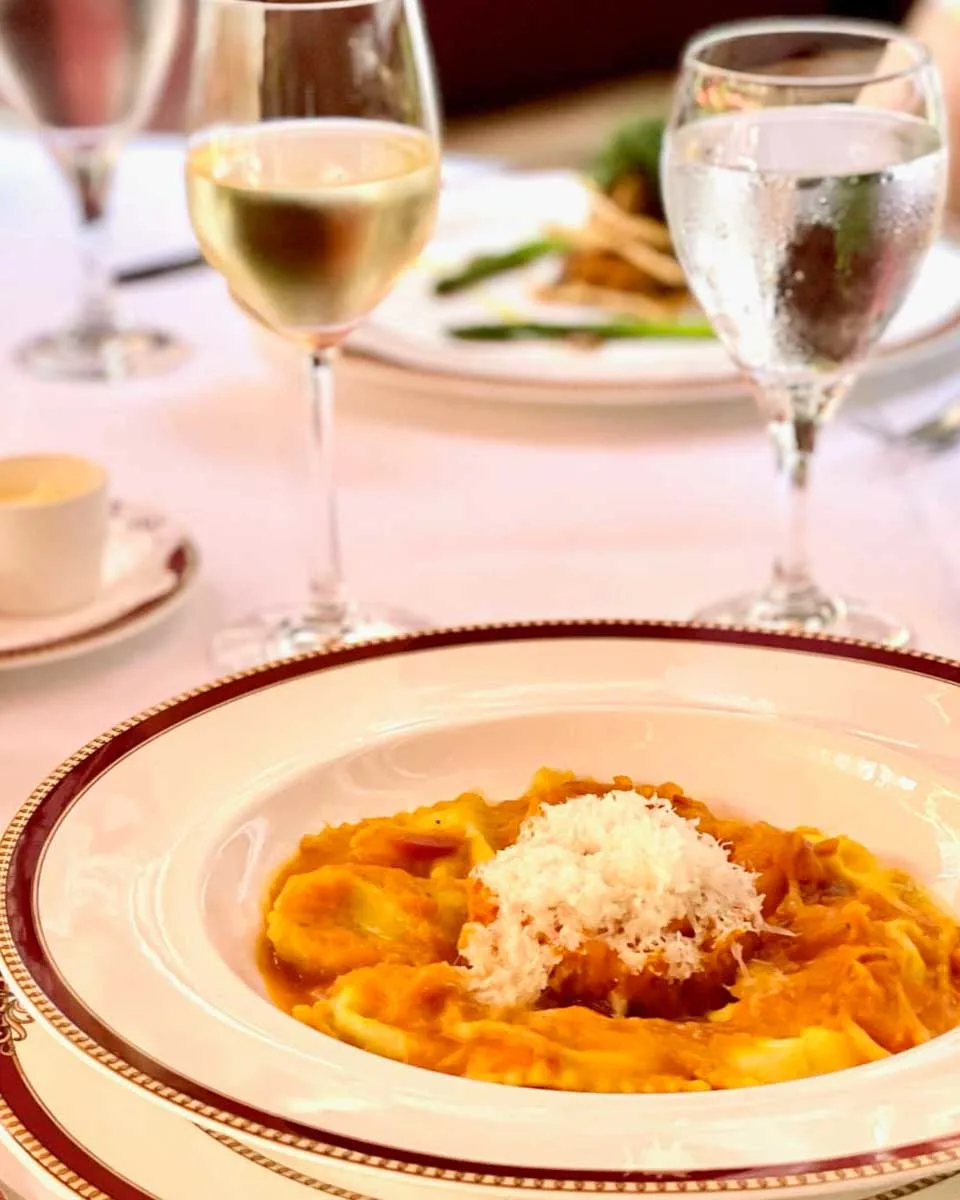 Restaurante Grano de Oro Ravioli on a set table with wine in San Jose, Costa Rica