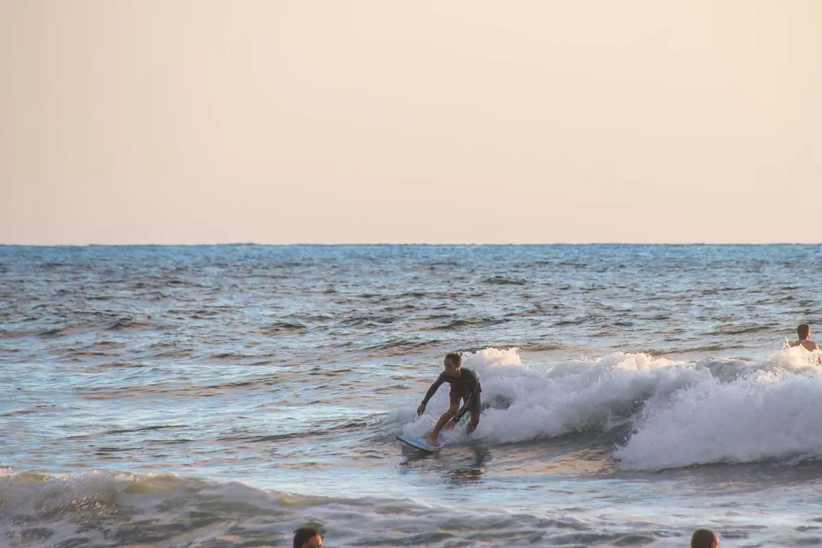 A man Surfing in Jaco, Costa Rica