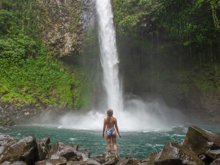 A lady stands in front of La Fortuna waterfall in Costa Rica