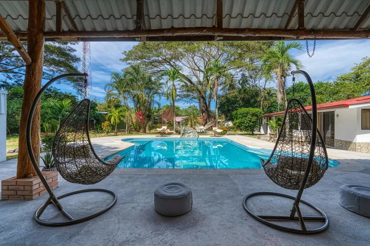 the pool and teo lounge chairs at Tribe Boutique Hotel in Dominical, Costa Rica