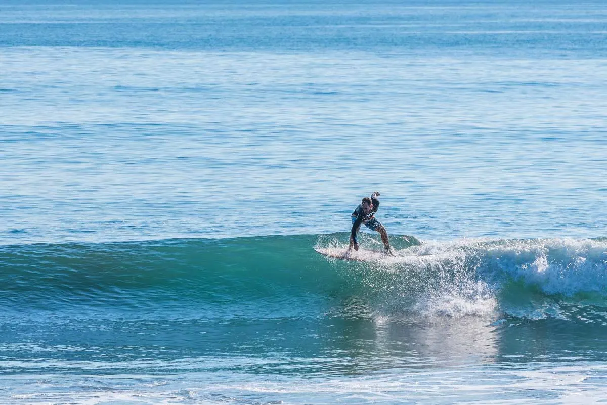 A persona surfing at Playa hermosa, Uvita