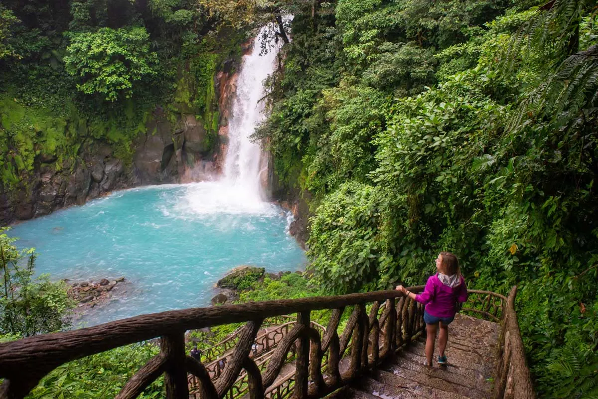 Bailey on steps looking at Rio Celeste Waterfall from above