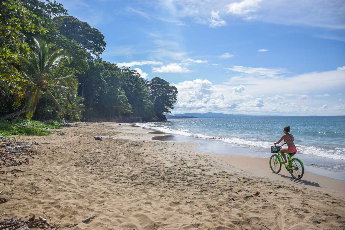 Bailey rides a bike on the beach at Punta Uva, Costa Rica