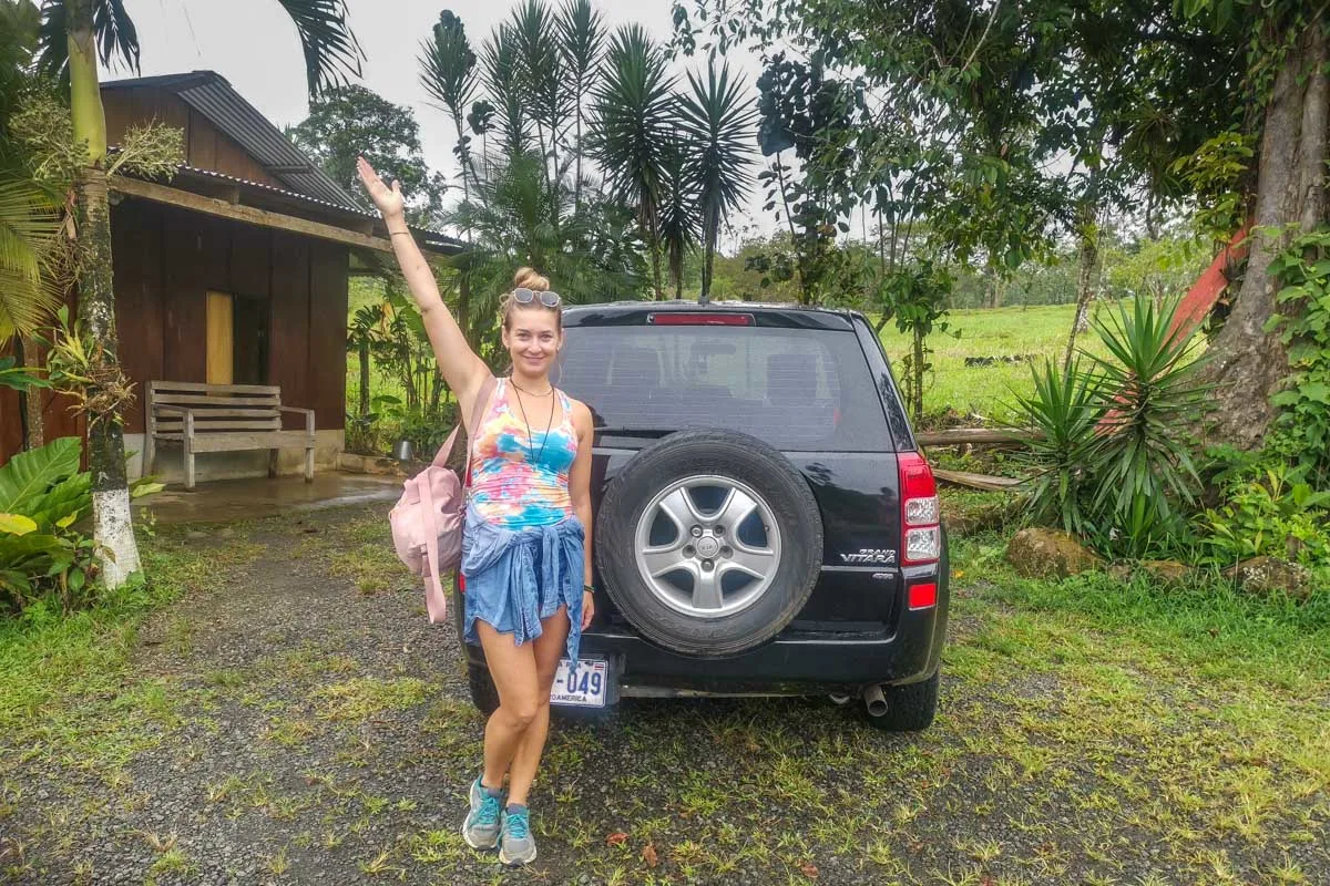 Bailey with our rental car near Rio Celeste Costa Rica
