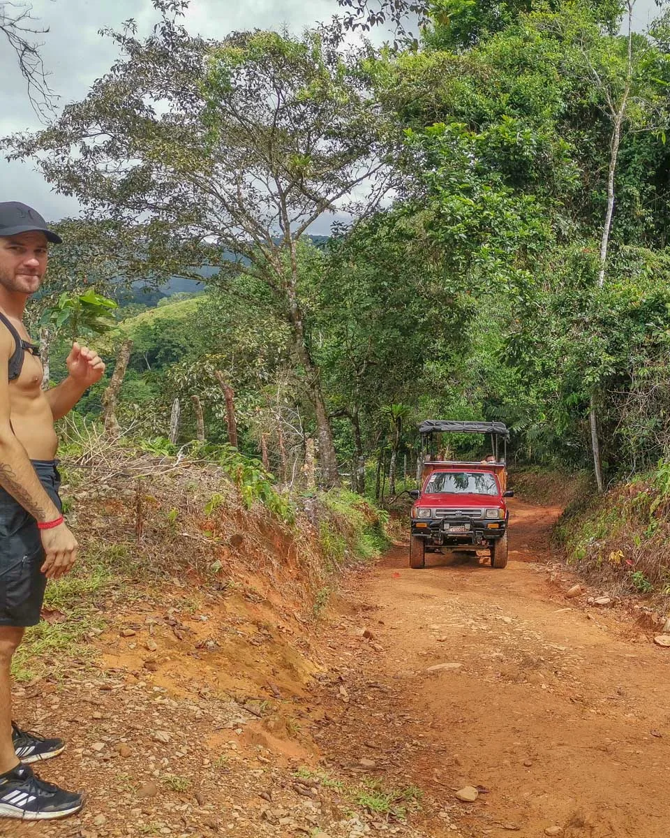 Daniel stands on the side of the road as the truck to Nauyaca Waterfalls drives past