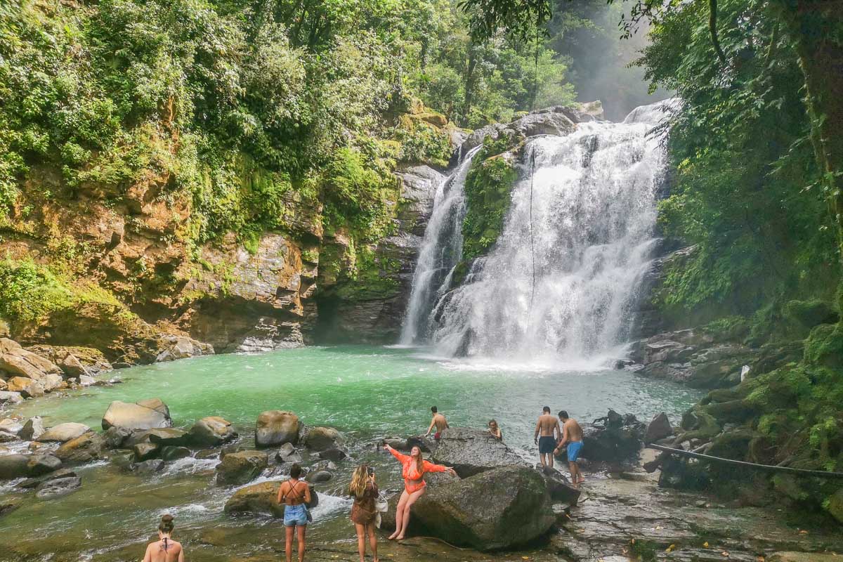 Nauyaca Waterfalls with a crowd of people taking photos