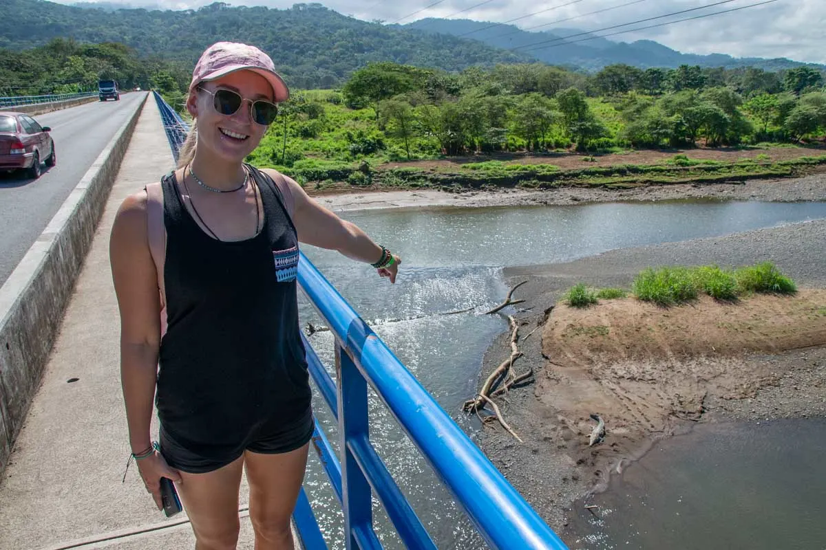 Bailey points to a crocodile on the Crocodile Bridge over the Tarcoles River