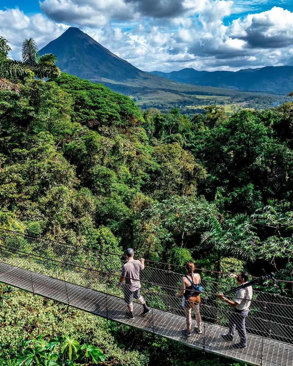at the bridge of Mistico Park with a view of Arenal Volcano in La Fortuna, Costa Rica