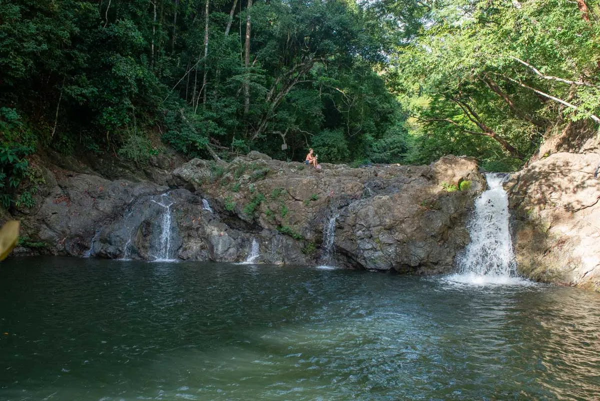 Bailey relaxes at the upper waterfall of the Montezuma Waterfall in Costa Rica