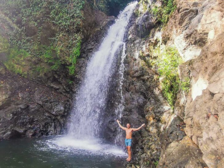 Daniel stands below the middle waterfall at the Montezuma Waterfalls in Costa Rica