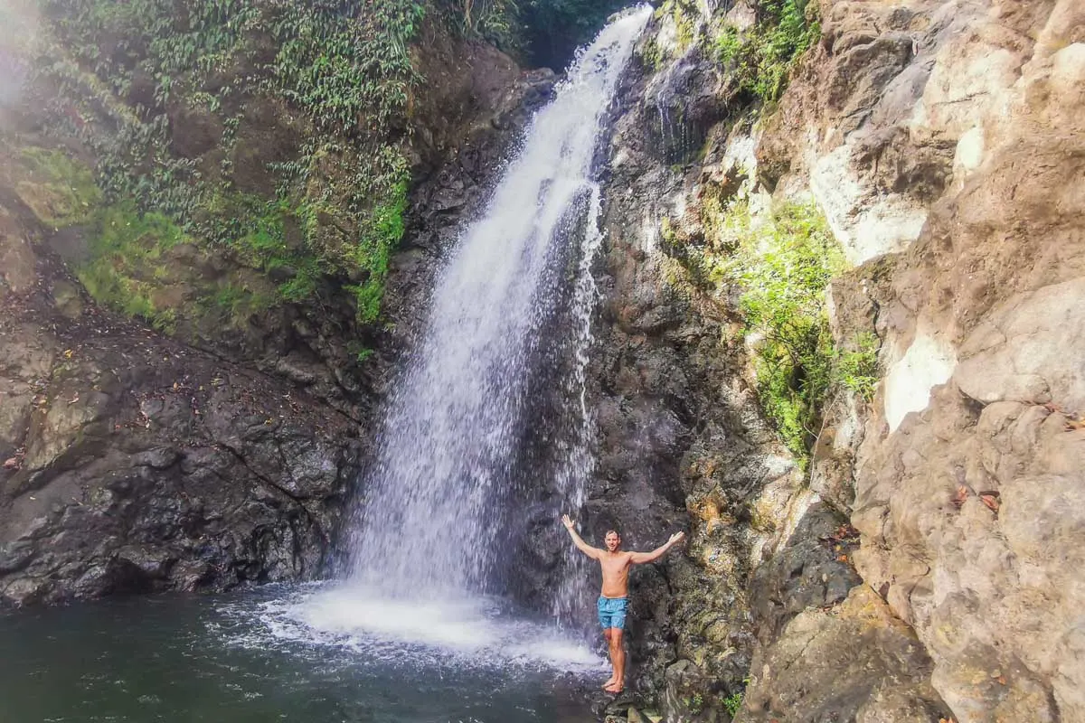 Daniel stands below the middle waterfall at the Montezuma Waterfalls in Costa Rica