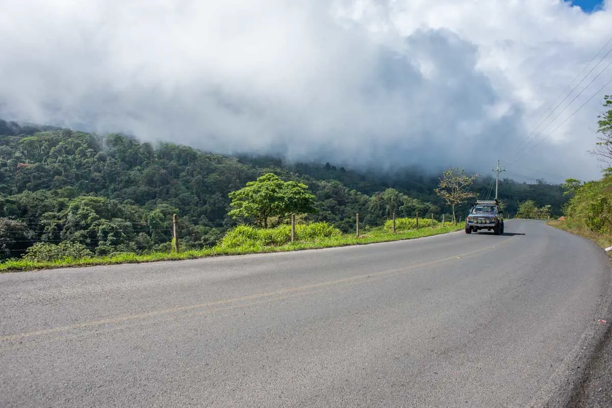 A 4WD drives along a highway in the hills of Costa Rica