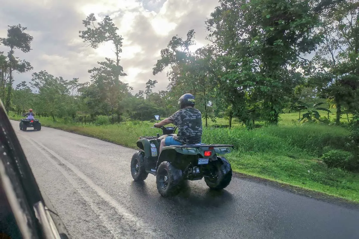 An ATV drives passed us while driving in Costa Rica