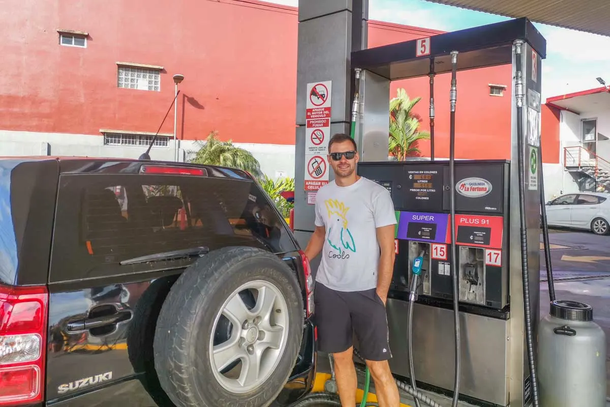 Daniel fills up our rental car in Costa rica