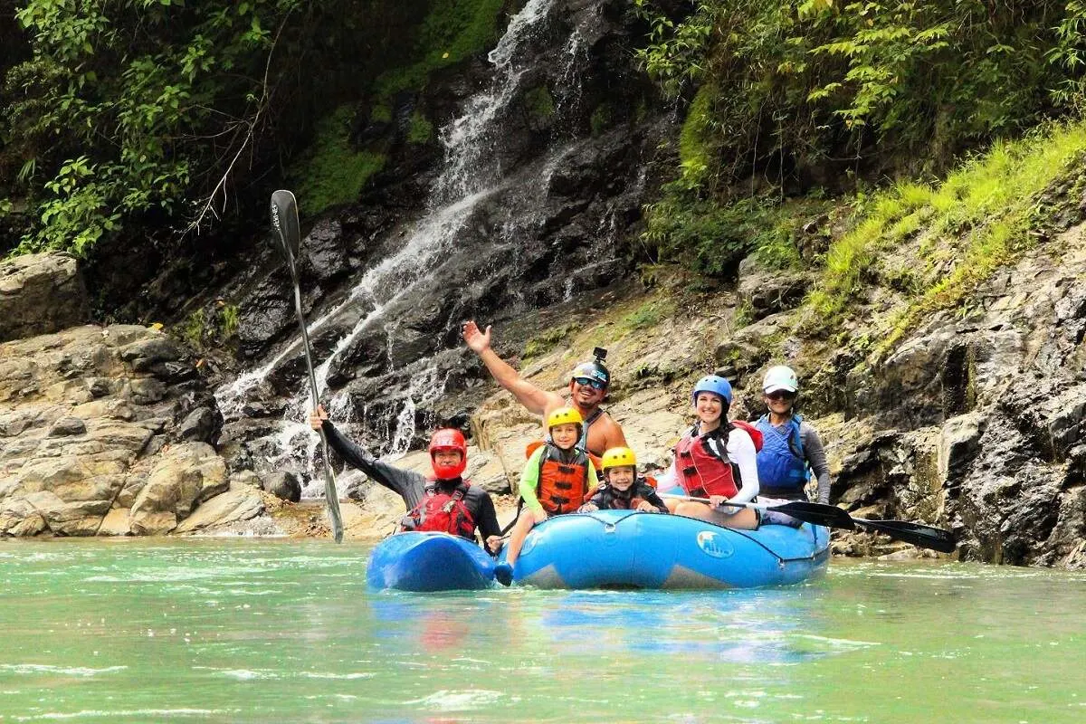 family with young child smiling on a whitewater rafting tour in Costa Rica