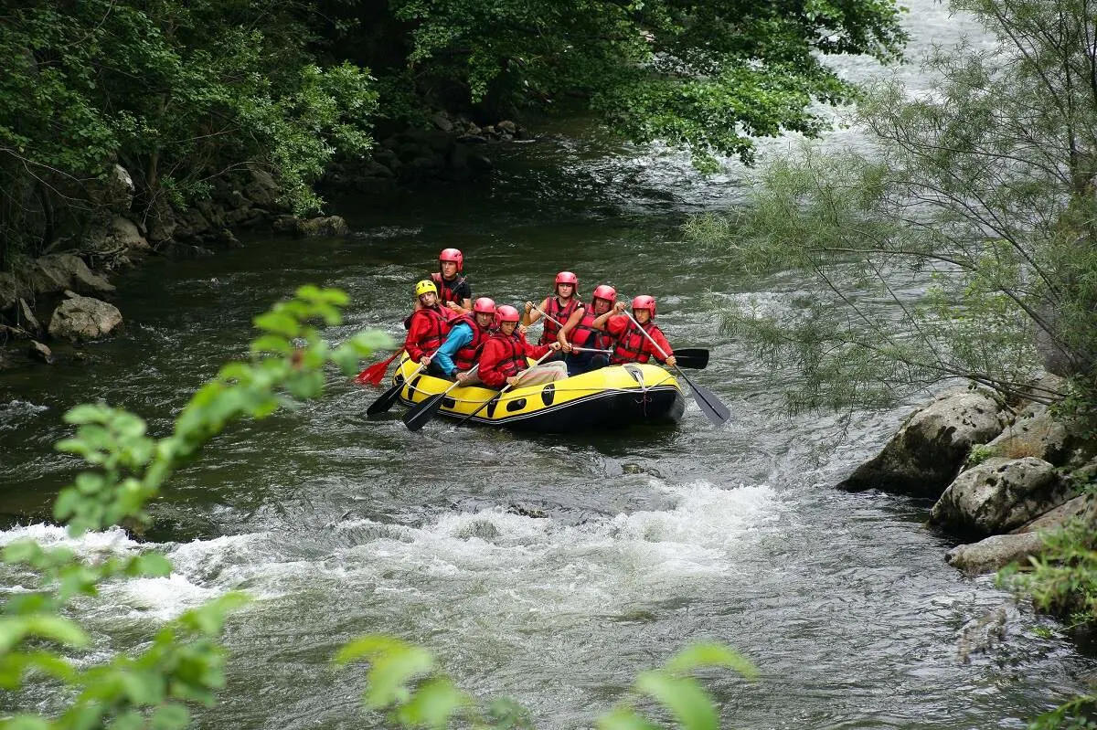 group of people in a yellow raft surrounded by lush jungle in Costa Rica
