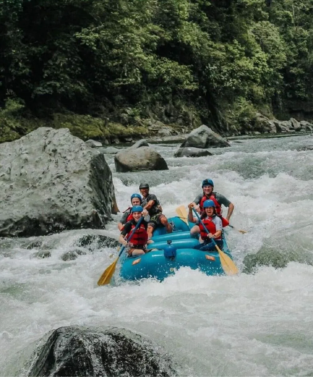 group of people on a blue raft in the Tenorio River