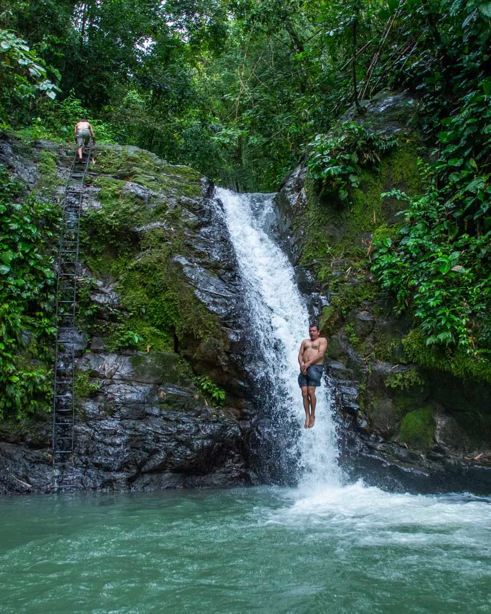 A man jumps from the top of Uvita Waterfall, Uvita