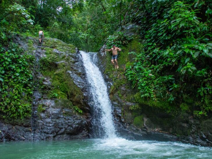 A man jumps into Uvita Waterfall