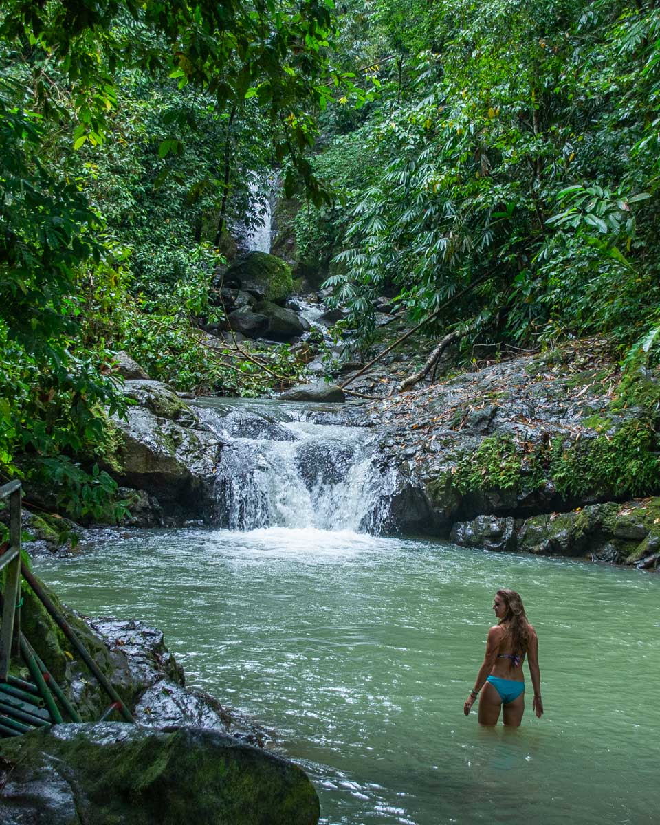 Bailey swims in the river pool below Uvita Waterfall in Uvita, Costa Rica