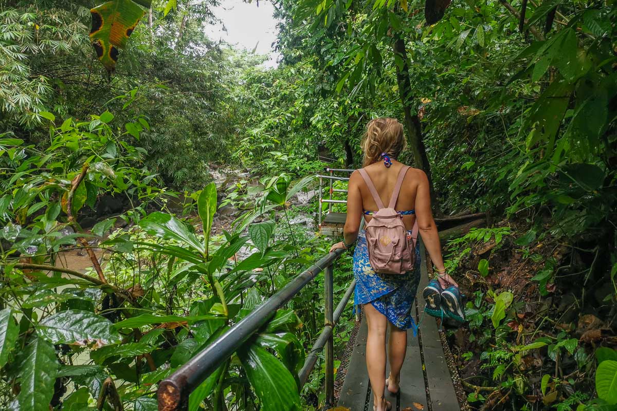 Bailey walks along the metal boardwalk at the pool of Uvita Waterfall, Costa Rica