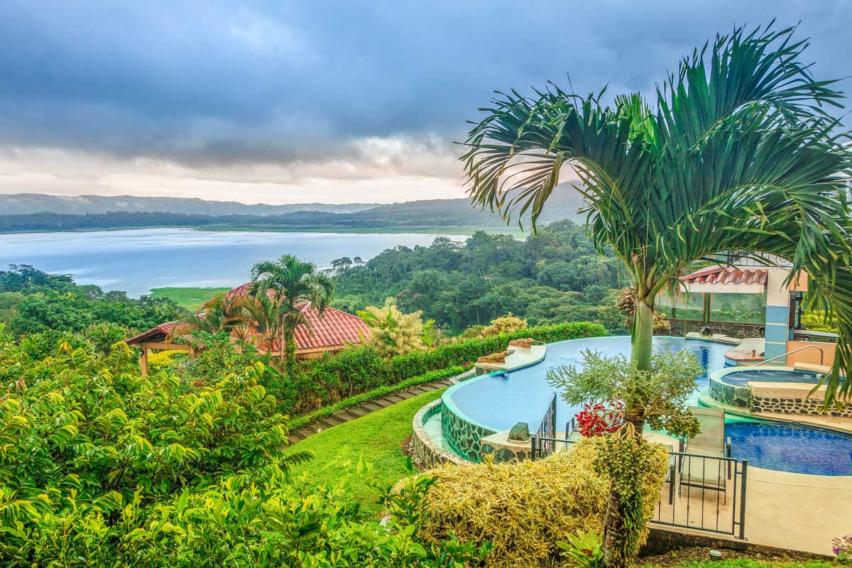 An all inclusive resort in Costa rica with a pool overlooking Lake Arenal