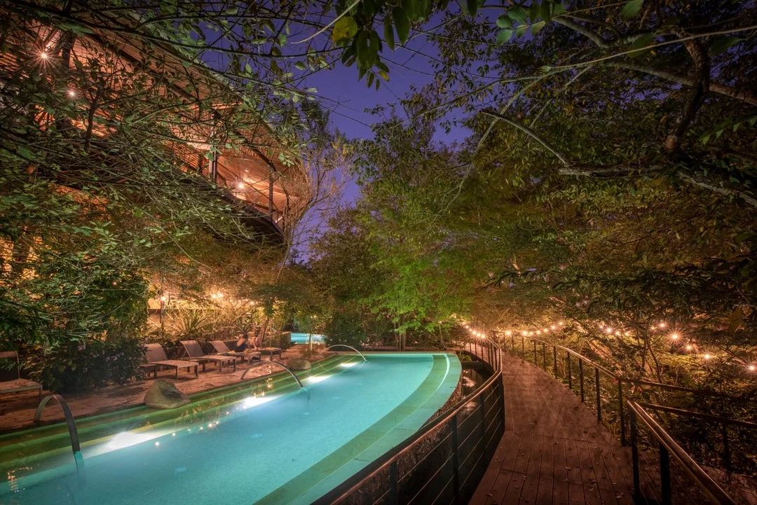 Rio Perdido hot pool at night surrounded by jungle